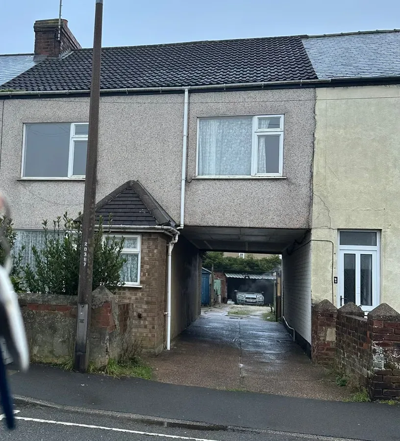 A rendered mid terrace house on Boughton Lane with a shared entry passage running through to the yards behind.